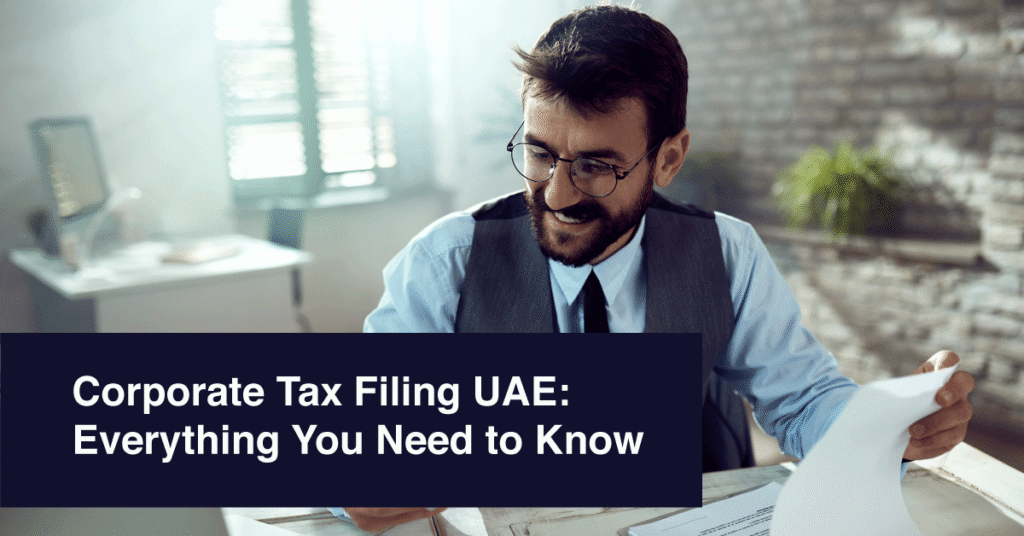 Corporate tax advisor in UAE reviewing documents at desk with headline Corporate Tax Filing UAE: Everything You Need to Know